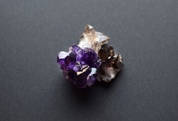 Smoky quartz and purple amethyst crystals on dark background. Semi-precious natural stones...