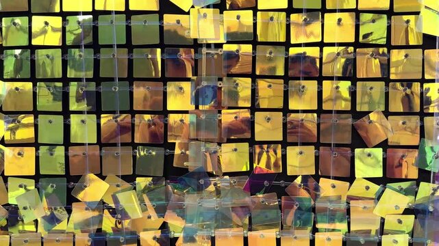 4k footage, close up of glimmering mirror sequin tile foil paper forming tinsels. Reflective glossy foil paper cut in square, christmas decoration. Reflection effects, various colors.