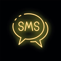 Bright yellow neon sms speech bubble is glowing on a black background