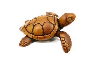 Naklejka premium Wooden Sea Turtle Figurine on White Background