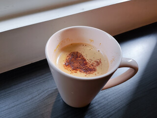 A cup of cappuccino or coffee in the morning with the light. Daily life, copy space, people's activities