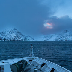 a speck of orange between the blue clouds