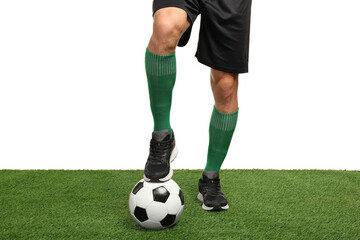 Football player with soccer ball on artificial grass against white background, closeup