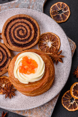 Sweet dessert danish covered with white cream and citrus, with cream filling