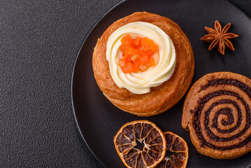 Sweet dessert danish covered with white cream and citrus, with cream filling