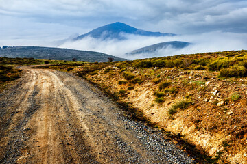 Road and fog at the Machotas peaks.