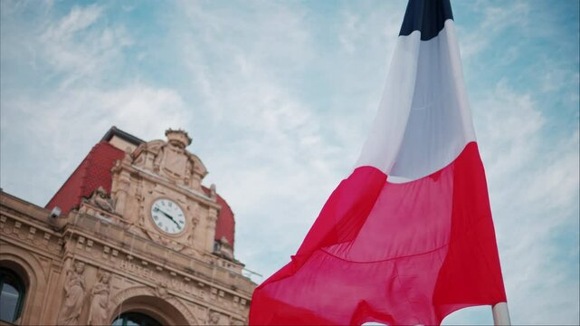 French flag waving in front of the Mairie de Cannes Town hall in Cannes, France