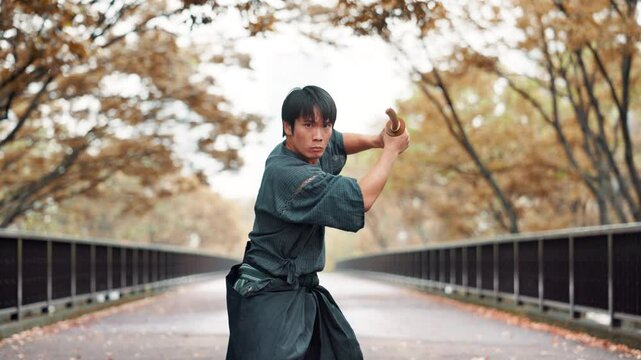 Martial arts, japanese man and bamboo weapon for kendo in street with traditional practice and skill development. Culture, serious samurai and sword for fighting technique, self defense and attack