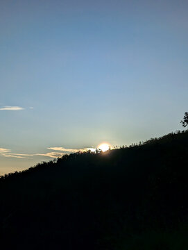 Sunrise over the mountains, with warm golden light casting a peaceful glow on the landscape