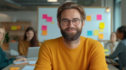 Obraz premium A cheerful team leader in a modern coworking space with brainstorming tools in the background, symbolizing creativity, collaboration, and leadership