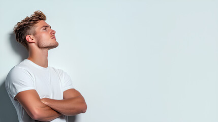 A man with a white shirt and short hair is standing in front of a white wall