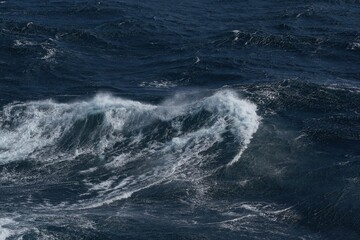 Dynamic ocean waves crashing against each other, creating dramatic seascape. deep blue water...