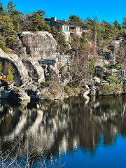 Reflection of a house on the cliff in the Minnewaska lake in Upstate New York