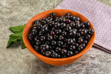 Ripe black currant in the bowl