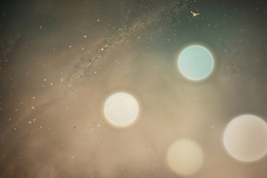 Vintage Ethereal Background with Soft Light Reflections and Grainy Dust Particles