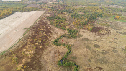 Dry, brown field with a river running through it