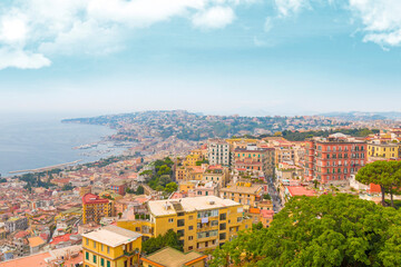 Fototapeta premium Captured from Sant'Elmo Castle, this photo reveals Naples’ vast cityscape, historic architecture, and iconic Mount Vesuvius framed by the Italian sky