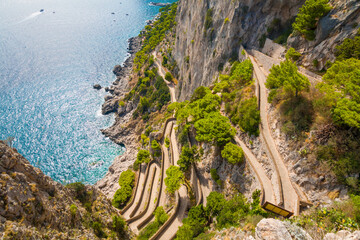 Captured on Capri Island, the photo reveals the historic Phoenician Steps, a steep stone staircase surrounded by natural beauty, leading up the cliffs with panoramic sea views.