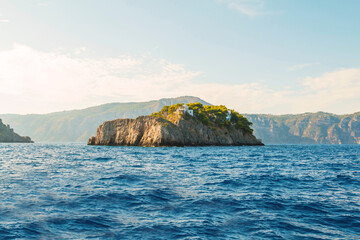 The photo captures the stunning Amalfi Coast from a cruise ship deck, showcasing dramatic cliffs, charming villages, and lush landscapes against the turquoise sea and vibrant blue sky.