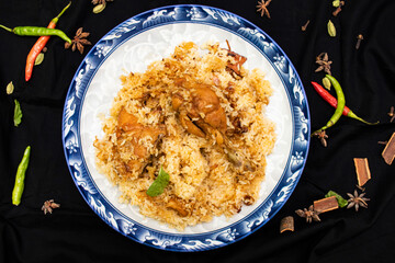 Chicken Biryani Rice served in plate isolated black background top view of indian, pakistani and bangladeshi spicy food