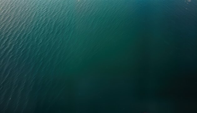 Overhead lake view shows deep blue water surface. Ripples create texture pattern. Natural liquid background ideal for summer themes. Water pool image perfect for website wallpaper. Clear deep blue