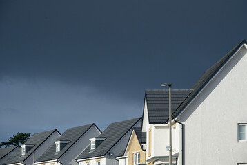 New housing development under dark storm clouds