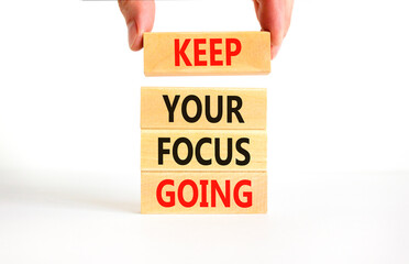 Keep your focus going symbol. Concept words Keep your focus going on beautiful wooden blocks. Beautiful white table white background. Business and keep your focus going concept. Copy space.
