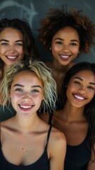 Four women with diverse hair and skin tones smile at the camera. Concept of diversity and friendship. For promoting beauty and diversity.