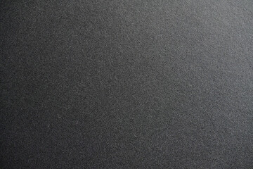 A textured black background for various design and creative projects.