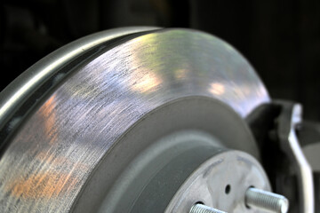 Close-up of a car brake disc showcasing intricate details and surface textures.