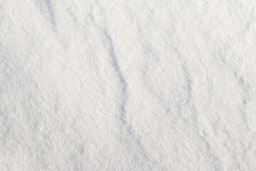 Obraz premium sunlit snow surface with rough texture, snow texture