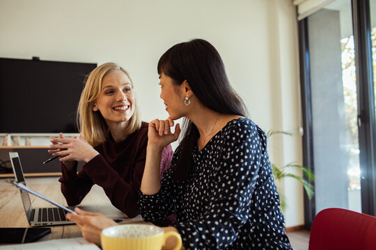 Two women discussing ideas at a office workplace