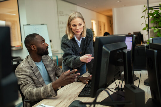 Diverse business people working together on office computer