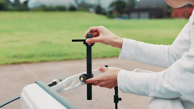 Hands, archery and outdoor with bow for training with equipment, ready or prepare for competition. Person, crossbow and gear for sport, field or start practice in summer for shooting contest in Japan