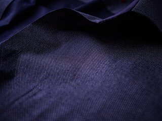 Close up of dark Men's shirt. Soft focus. Copy space.	