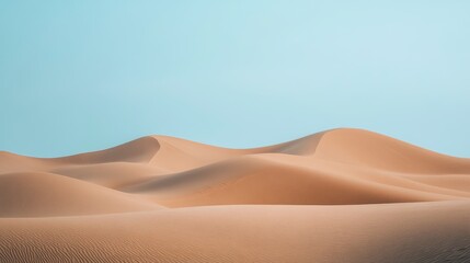Rolling Sand Dunes Under a Pale Blue Sky
