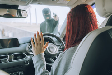 A robber with a gun and a mask attacked a female driver