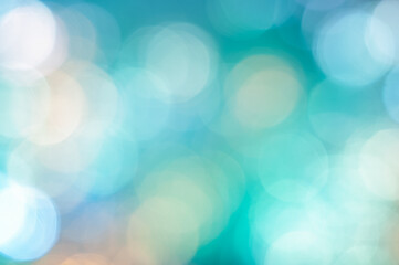 Soft bokeh lights creating a dreamy atmosphere on a clear blue background