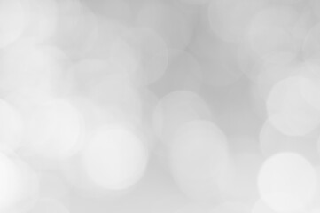 Soft white bokeh lights creating a dreamy atmosphere in a light background