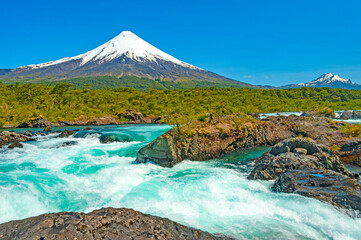 Petrohué Waterfalls (Saltos del Petrohué) in the Vicente Pérez Rosales National Park, with Osorno volcano in the background. © sphraner