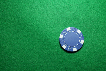 Poker chip on green table, top view. Space for text