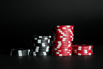 Poker game. Casino chips on black background