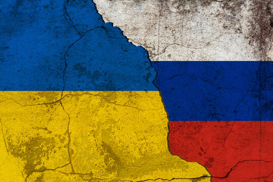 Diplomatic relations between Ukraine and Russia. Flag of the two countries with cracked wall texture. War between Russia and Ukraine.