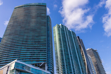 Skyscrapers, hotels and luxury condos in the city skyline at sunset with blue sky and clouds in Miami Florida USA