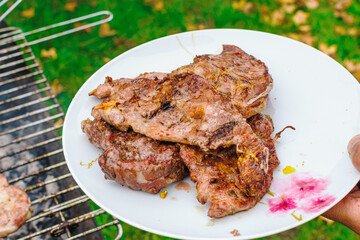Iberian pork meat grilled on a plate in an outside summer lunch