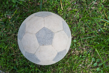 The old football is on grass field.