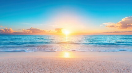 The sun is setting over the ocean, casting a warm glow on the water