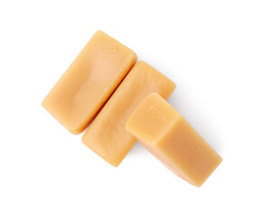 Tasty sweet caramel candies isolated on white, top view