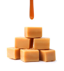 Caramel sauce dripping onto candies on white background, closeup