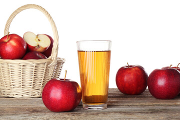 Tasty apple juice in glass and fresh fruits on wooden table against white background
